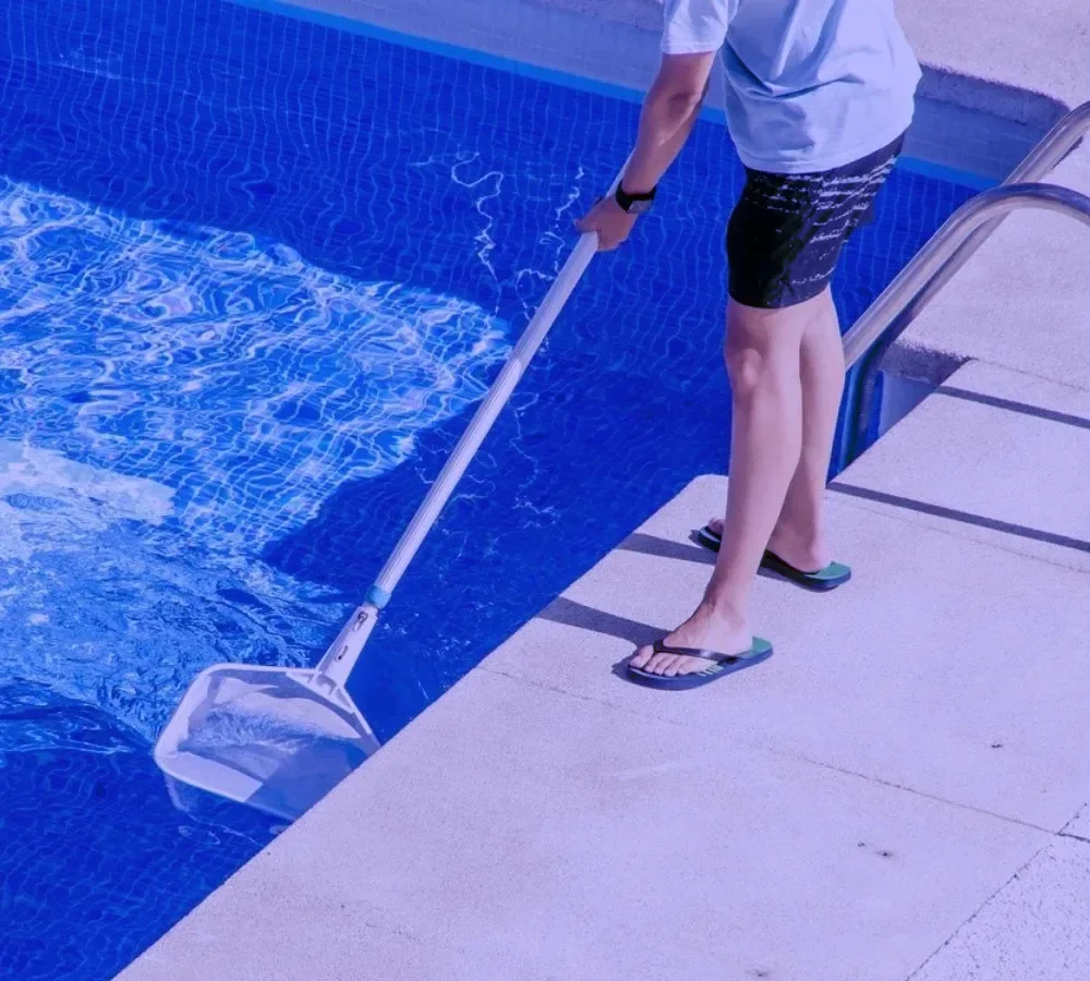 A man servicing a pool